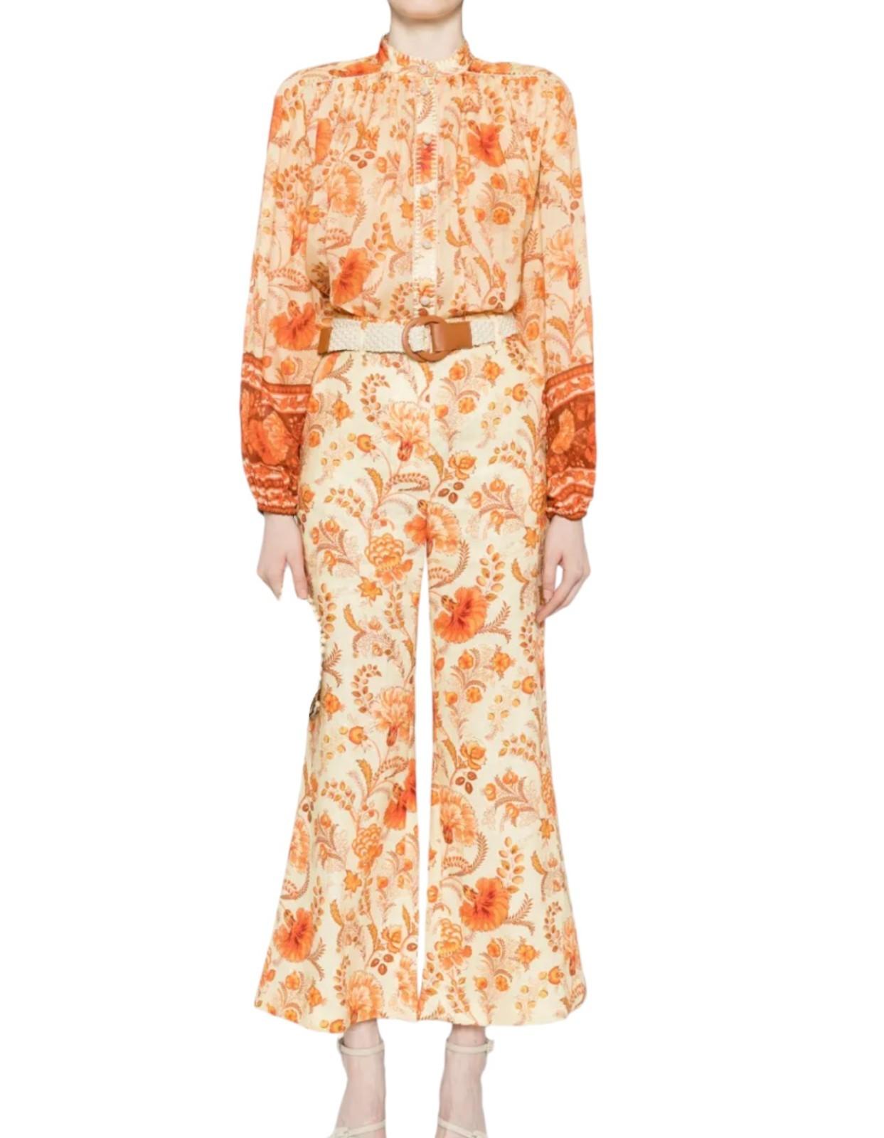 Person wearing an orange floral outfit on a white background